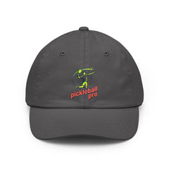 A charcoal gray dad hat with a colorful embroidered logo of a person playing pickleball and the words "pickleball pro" in green and orange.