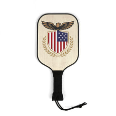 A single wooden pickleball paddle featuring a black-rimmed face with an American eagle and shield graphic, and a black wrapped handle.
