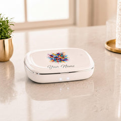 A white rectangular UV sanitizer box with a colorful watercolor splash design and the text Your Name rests on a wooden bedside table.